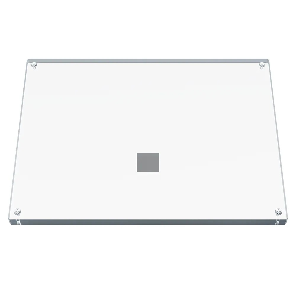Rectangular transparent plate with a metal square inside.