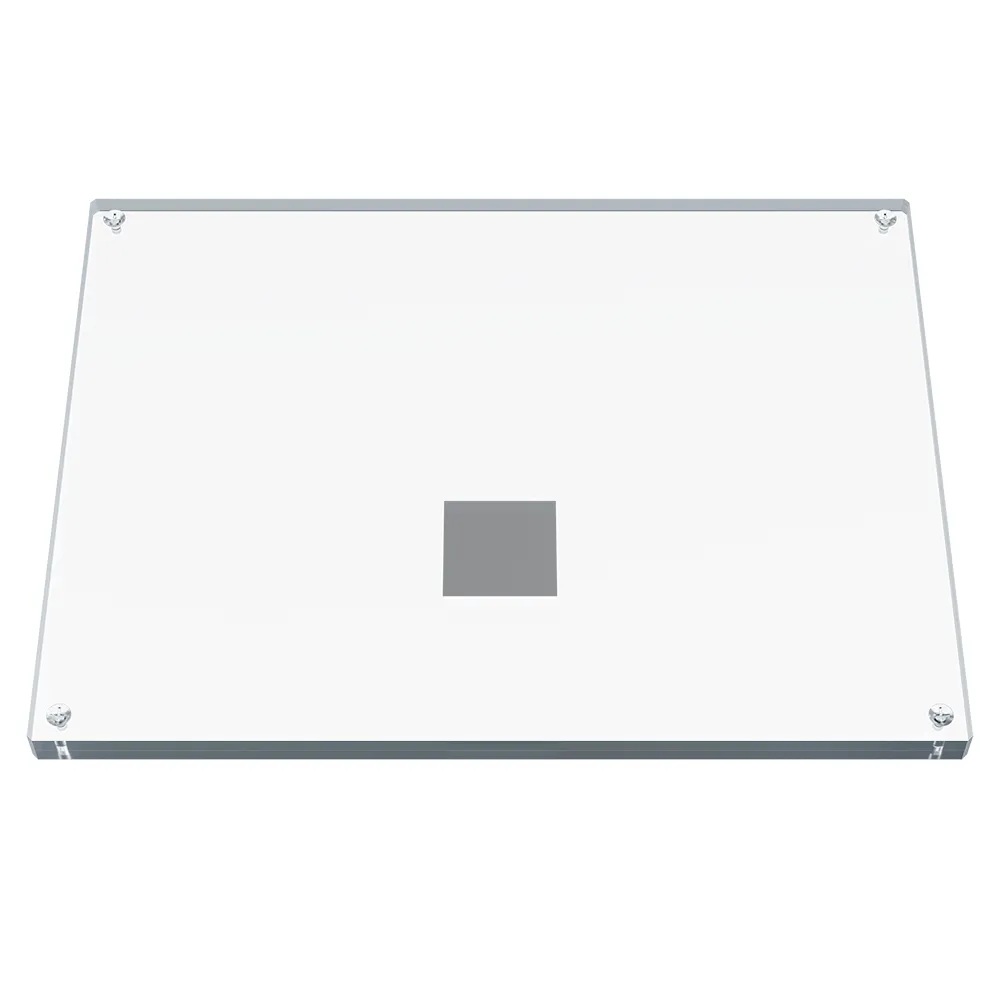 Rectangular transparent plate with a metal square inside.