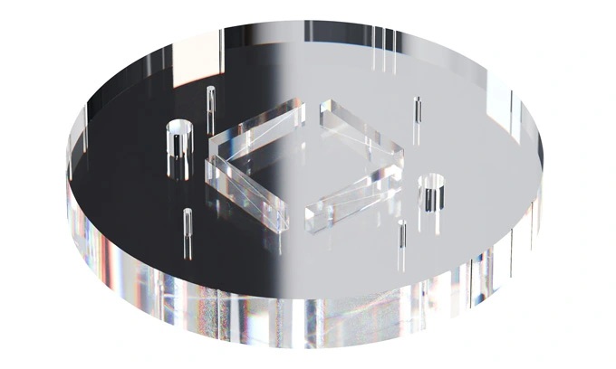 A transparent acrylic round plate with two pairs of aluminium ramps and empty rods in vertexes of a square.